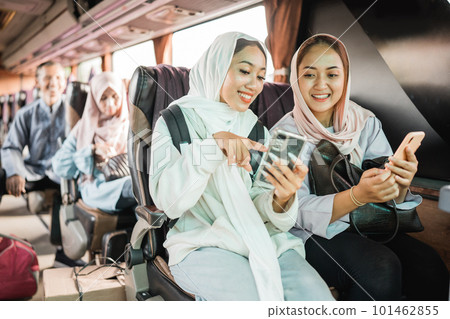 happy muslim woman using phone while travel by bus 101462855