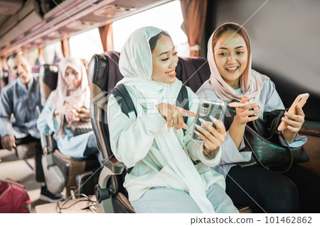happy muslim woman using phone while travel by bus happy muslim woman using phone while travel by bus 101462862