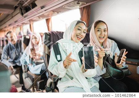 happy muslim woman using phone while travel by bus 101462864