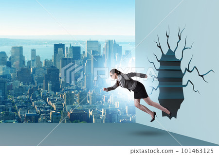 Businesswoman breaking through the wall 101463125