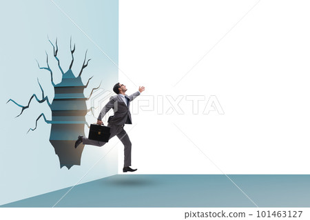 Businessman breaking through the wall 101463127