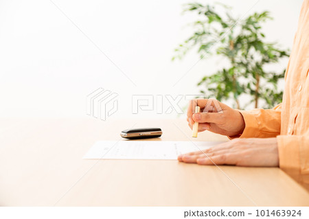 Senior's hand stamping a seal on the contract 101463924