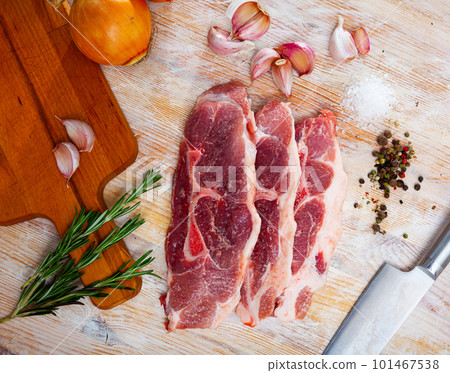 Preparation of raw pork shoulder on wooden board Preparation of raw pork shoulder on wooden board 101467538