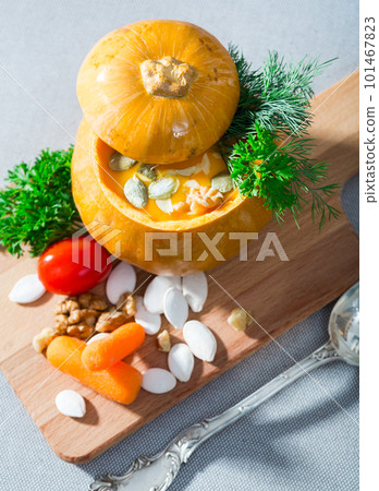 Cooked homemade vegetable pumpkin cream soup in pumpkin 101467823