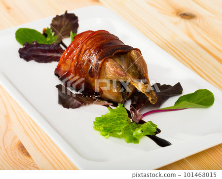 Plate with quail baked in bacon 101468015