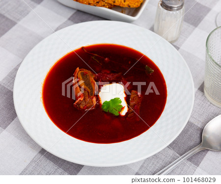 Beetroot soup with beef meat served with sour cream and greens Beetroot soup with beef meat served with sour cream and greens 101468029