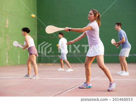 Woman Basque pelota player hitting ball with wooden racket Woman Basque pelota player hitting ball with wooden racket 101468053