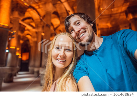 Happy couple enjoying Beautiful cistern in Istanbul. Cistern - underground water reservoir build in 6th century, Istanbul, Turkey, Turkiye Happy couple enjoying Beautiful cistern in Istanbul. Cistern - underground water reservoir build in 6th century, Istanbul, Turkey, Turkiye 101468654
