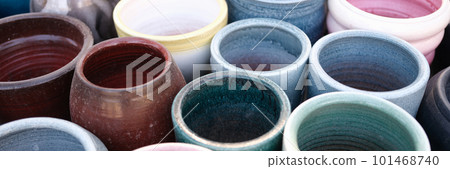 Empty colourful ceramic flower pots in greenhouse or hothouse 101468740