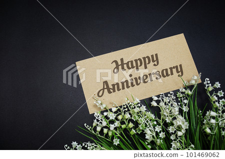 Happy Anniversary text message with flower decoration on black background Happy Anniversary text message with flower decoration on black background 101469062