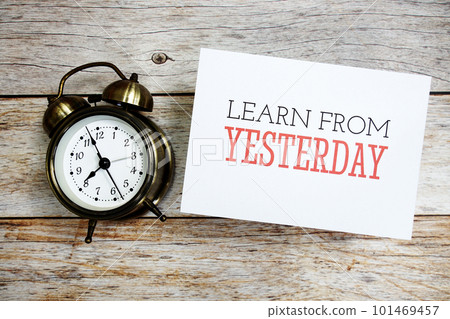 Learn from Yesterday text message with alarm clock on wooden background Learn from Yesterday text message with alarm clock on wooden background 101469457