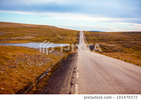 Driving a car on road in tundra. Nature of Norway. Polar circle. The way to Nordkapp Driving a car on road in tundra. Nature of Norway. Polar circle. The way to Nordkapp 101470372