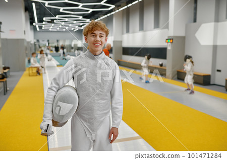 Happy smiling young fencer portrait over gym interior of martial sport school 101471284
