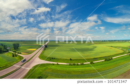 Summer rural landscape, aerial view. View of green fields, forest, village and highway Summer rural landscape, aerial view. View of green fields, forest, village and highway 101471347