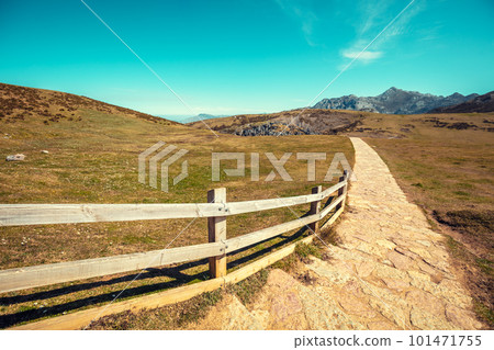 Mountain range, valley and walkway with fence 101471755