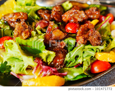 a plate of hot salad with caramelized meat. a plate of hot salad with caramelized meat. 101471772