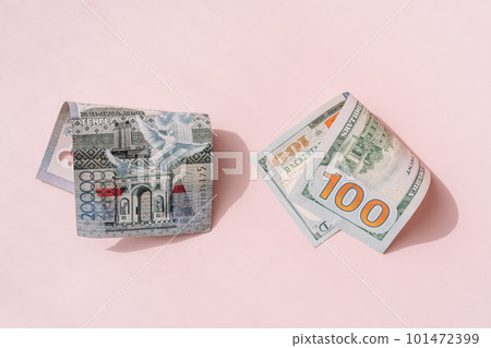 One hundred dollar bill and twenty thousand tenge on a pink background One hundred dollar bill and twenty thousand tenge on a pink background 101472399