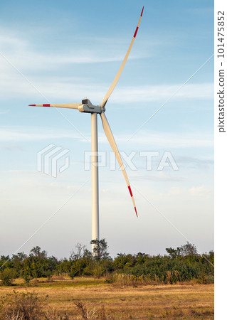 Wind turbine, alternative energy, wind energy, one windmill in a field in the mountains, top view of a wind turbine at sunset. 101475852