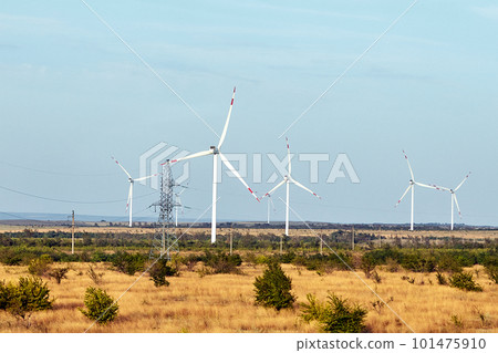 Wind energy. Wind power. Sustainable, renewable energy. Wind turbines generate electricity. Windmill farm on mountain with sunset sky. Green technology. Renewable resource. Sustainable development. 101475910