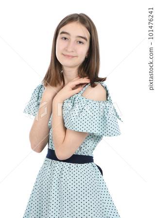 Young beautiful girl in a dress with polka dots on a white background.  101476241