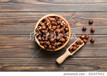 Wooden bowl full of hazelnuts on table background. Healthy eating concept. Super foods 101477452