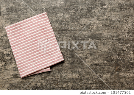 top view with red empty kitchen napkin isolated on table background. Folded cloth for mockup with copy space, Flat lay. Minimal style top view with red empty kitchen napkin isolated on table background. Folded cloth for mockup with copy space, Flat lay. Minimal style 101477501