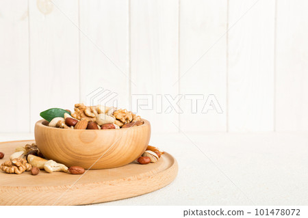 mixed nuts in bowl. Mix of various nuts on colored background. pistachios, cashews, walnuts, hazelnuts, peanuts and brazil nuts 101478072