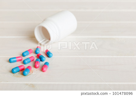 plastic medicine bottle with capsules of pills on colored background. Online pharmacy. Painkiller medicine and antibiotic drug resistance concept. Pharmaceutical industry 101478096