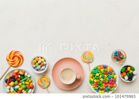 Coffee cup with chocolates and colored candy. Top view on table background with copy space 101478965