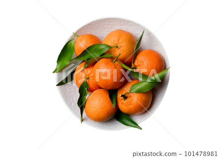 Fresh cutted clementines and whole mandarin over round plate isolated on white background. Food and drink ingredients preparing. healthy eating theme top view with copy space 101478981
