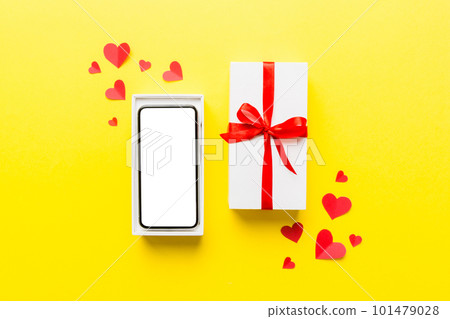 Opened gift box with ribbon and phone on color background, top view. Blank open box packaging mockup , Template for your design - branding mockup 101479028