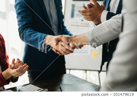 business people shaking hands during a meeting in office. 101479619
