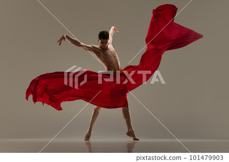 Impression. Handsome young man, professional ballet dancer dancing with red silk fabric against grey studio background Impression. Handsome young man, professional ballet dancer dancing with red silk fabric against grey studio background 101479903