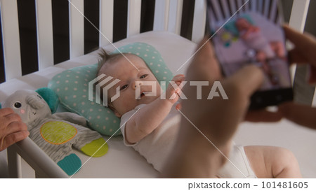 Couple takes a picture or video of little baby 101481605