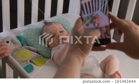 Couple takes a picture or video of little baby Couple takes a picture or video of little baby 101481644