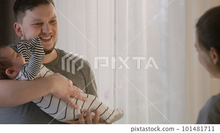 Man lulls newborn baby in bodysuit before day nap Man lulls newborn baby in bodysuit before day nap 101481711