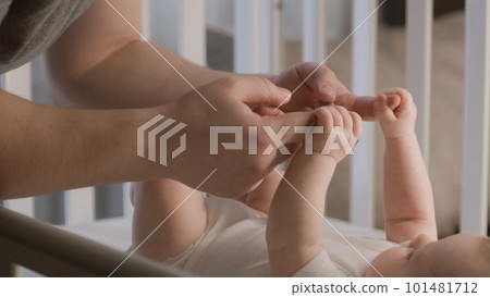Father plays with adorable baby in child crib Father plays with adorable baby in child crib 101481712