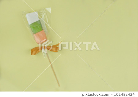 Traditional colored marshmallows for the holiday on yellow background. Top view. Traditional colored marshmallows for the holiday on yellow background. Top view. 101482424