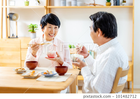 Senior couple eating in the dining room Senior couple eating in the dining room 101482712