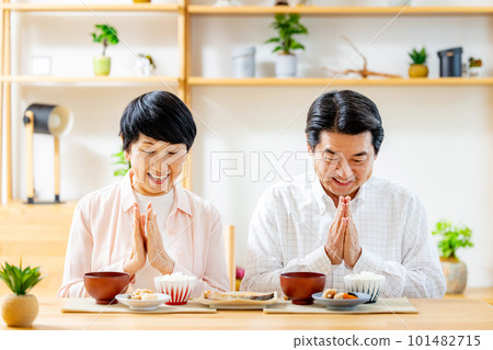 Senior couple eating in the dining room Senior couple eating in the dining room 101482715