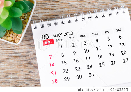 The May 2023 desk calendar for 2023 with plant pot on wooden background. 101483225