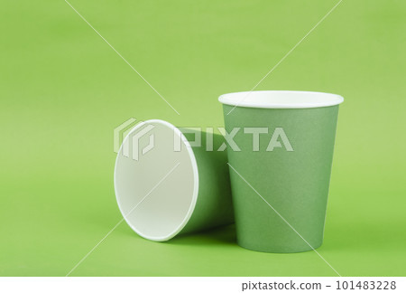 The green paper cup for takeaway on a green color background. 101483228