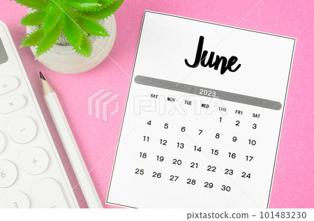 The June 2023 Monthly calendar for 2023 year with calculator on pink background. 101483230