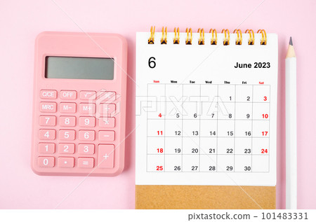 The June 2023 desk calendar for 2023 year with calculator on pink color background. 101483331