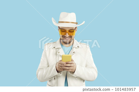 Smiling guy use cellphone text online Smiling guy use cellphone text online 101483957