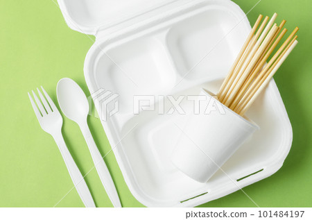 The Eco friendly biodegradable paper disposable for packaging food and paper glass on green background. The Eco friendly biodegradable paper disposable for packaging food and paper glass on green background. 101484197