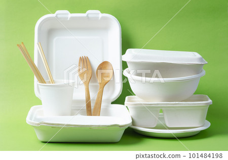 The Eco friendly biodegradable paper disposable for packaging food and paper glass on green background. 101484198
