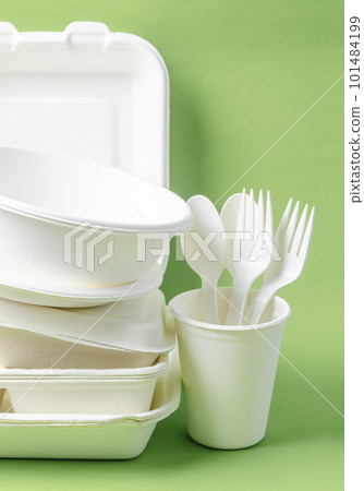 The Eco friendly biodegradable paper disposable for packaging food and paper glass on green background. 101484199
