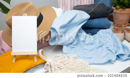 Reduce and reuse concept. Preparing clothes for swap. Waste problem in fashion industry. Vertical storage of clothing, tidying up, garments declutter and sorting. Copy spase 101484839