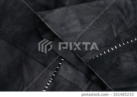 Sleeve detail of a black suede jacket with white contrast stitching 101485233